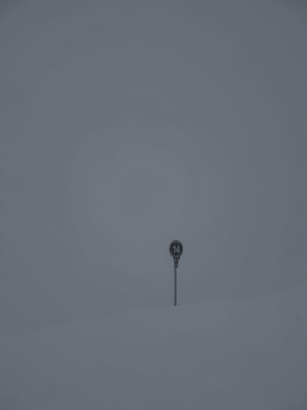 A lone piste marker in a total whiteout at Grands Montets.