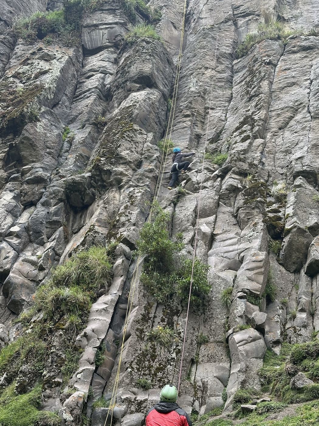 The canyon wall at La Chorrera, a climber in red at its base.