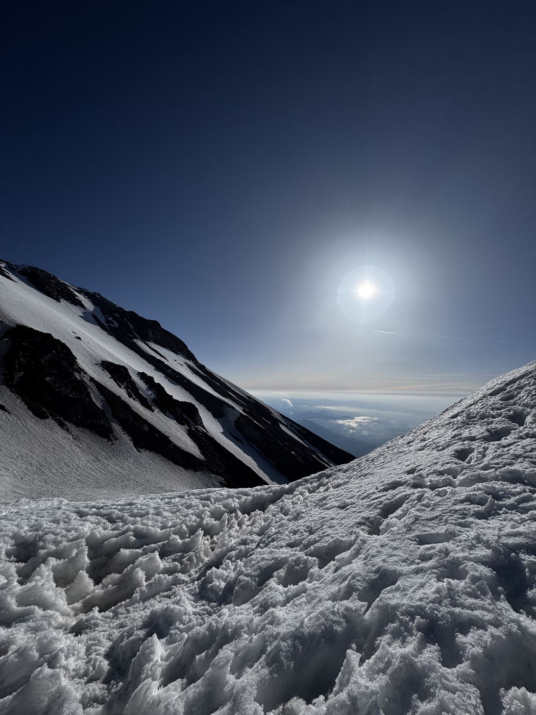 The sun over a snowfield high on Mount Shasta.